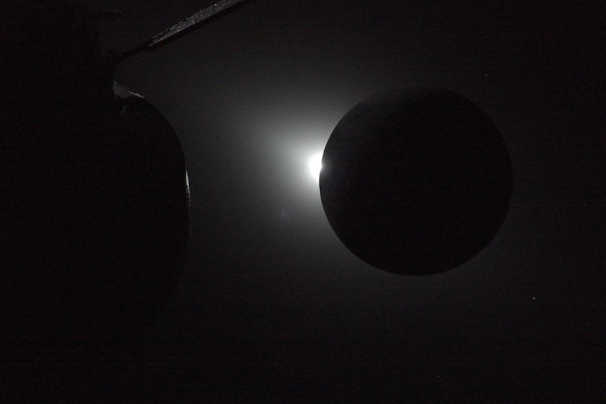 The Sun is rising at the left edge of the Moon during an eclipse