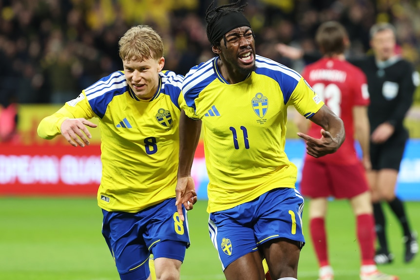 Anthony Elanga of Sweden celebrates scoring his team's first goal against Poland with teammate Daniel Svensson.