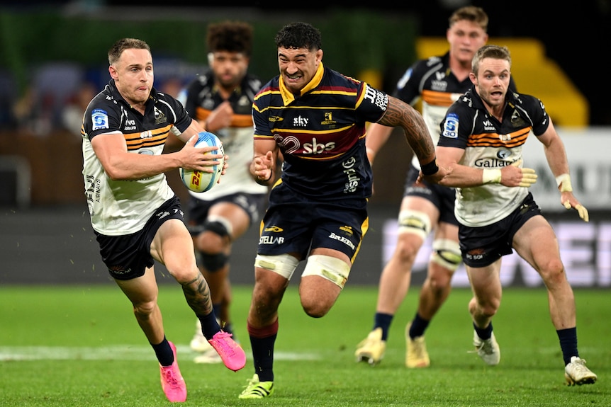 Corey toole makes a break for the Brumbies against the Highlanders.