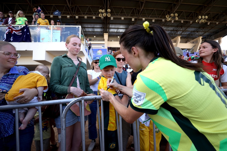 Hayley Raso signs autographs after a Matildas game against Malawi in Nairobi, Kenya.