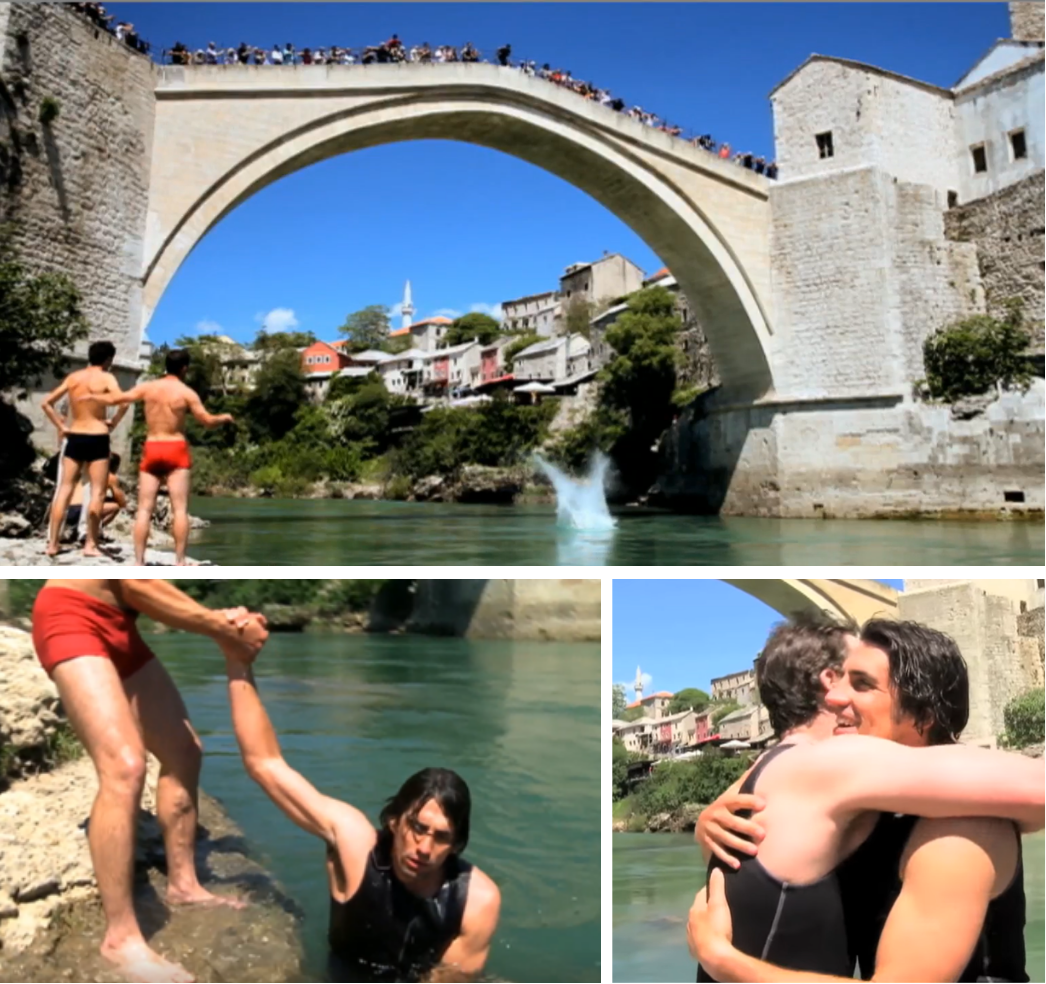 Andy and Hamish recovering and embracing after jumping from a tall bridge.