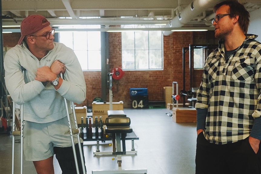 Sam Williamson, on crutches, and VIS gym coach Jono Wallace