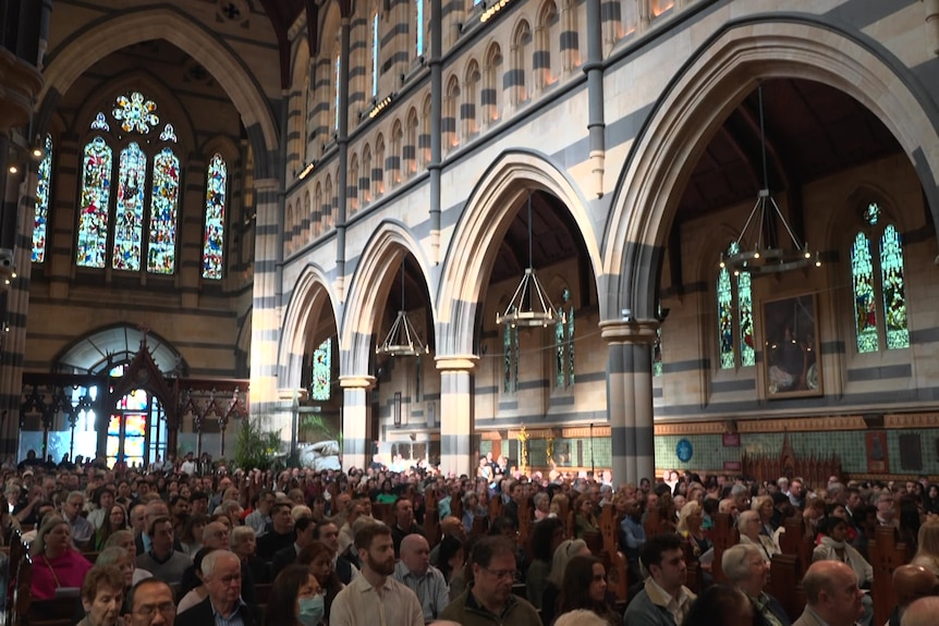 A large congregation gathered in pews inside St Pauls Cathedral
