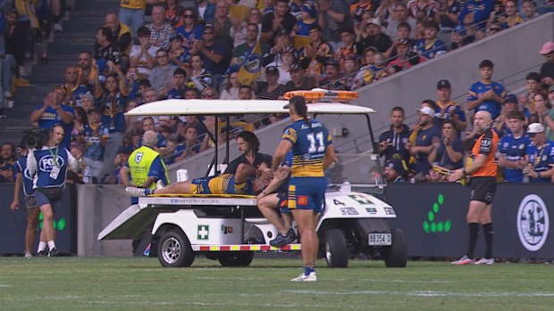 Bailey Simonsson is assisted off the field via a medicab.