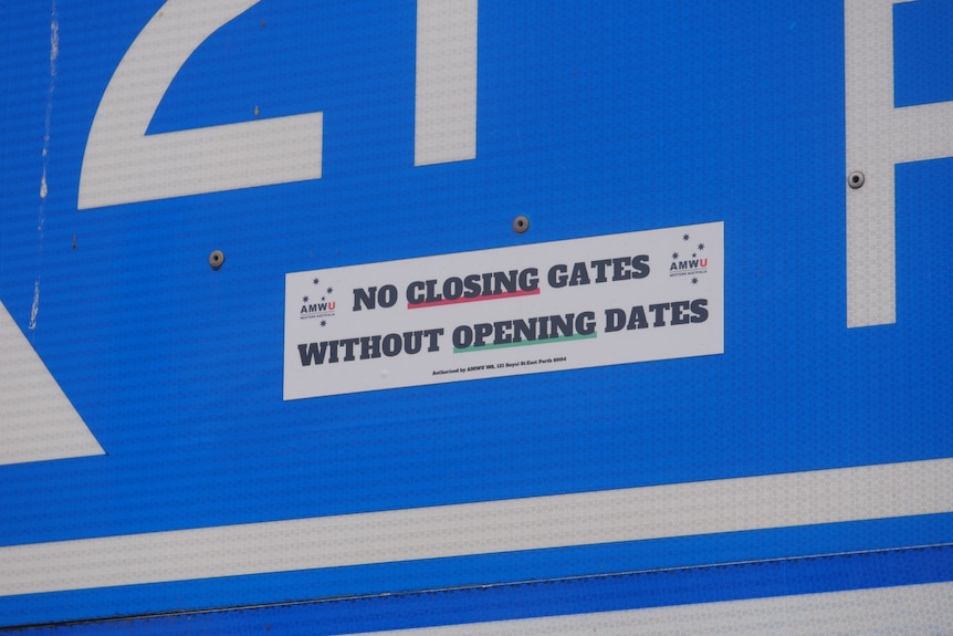 A union sticker stuck to a road sign in Collie.