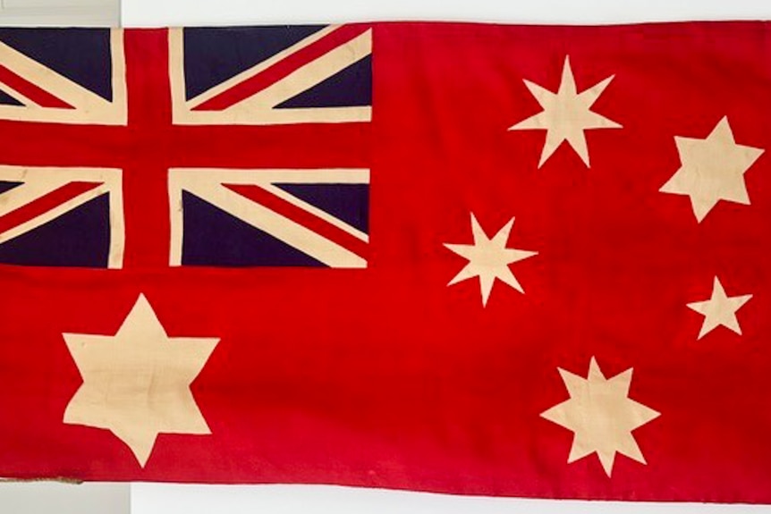 A close-up photo of a red ensign from 1915 after restoration