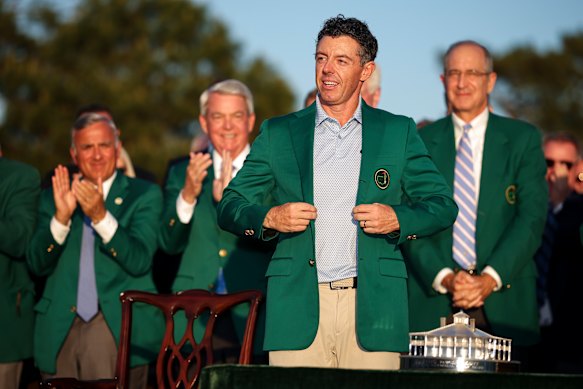 Rory McIlroy puts on the coveted green jacket after his Masters win.