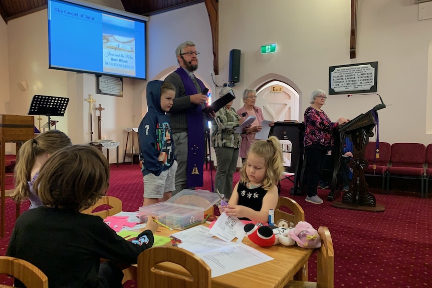 kindergarten craft table beside lectern  