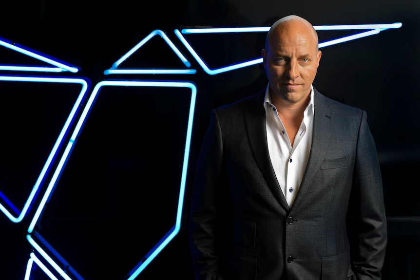 Man in suit looks at camera 