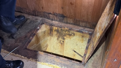 A tunnel being propped open by someone's hand