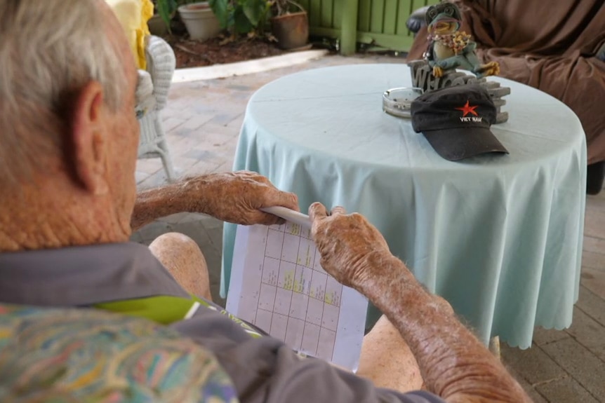 A man sitting with his back to the camera