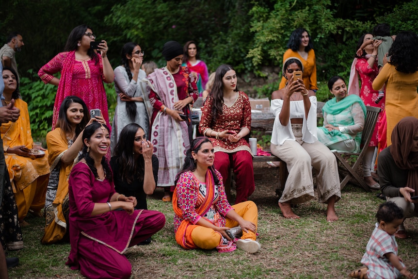 A group of South Asian women sitting outside
