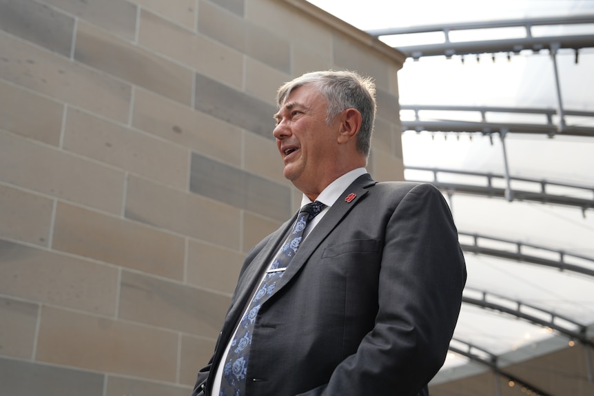 Wayne talks to media in the building.