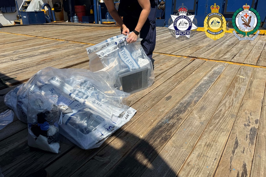 A police officer zipping up a bag