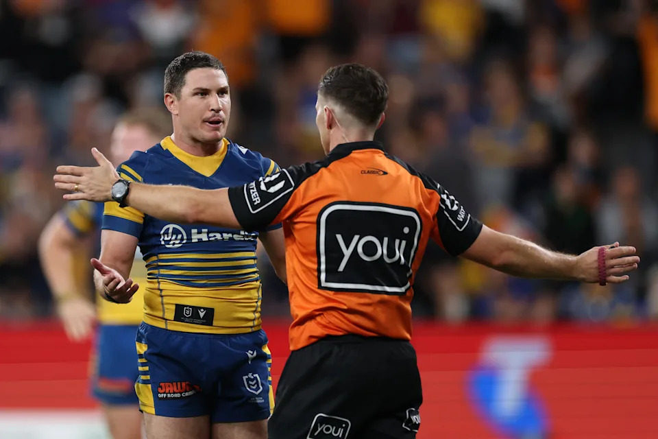 Mitchell Moses speaks to referee Peter Gough.