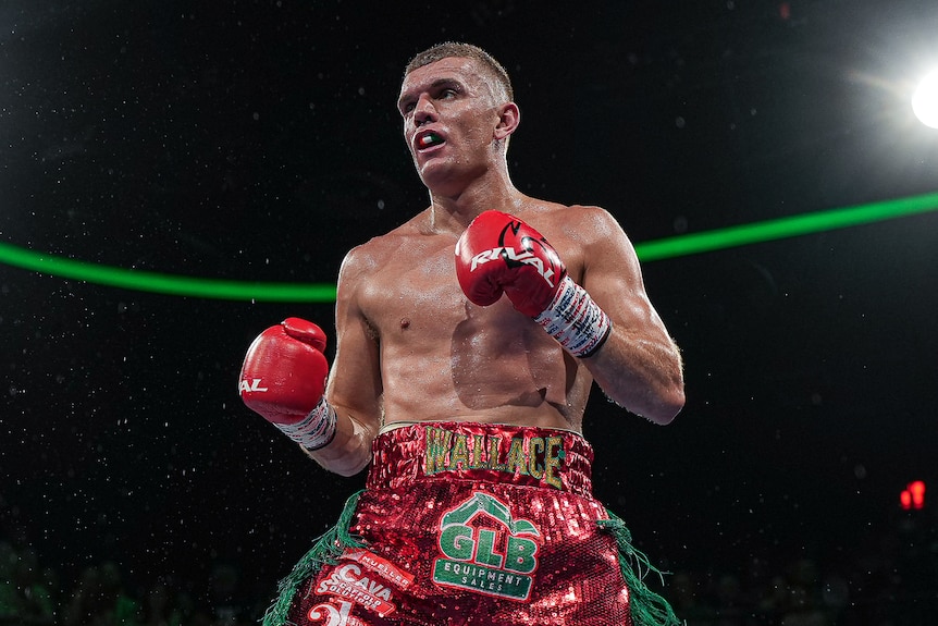Conor Wallace stands in the ring
