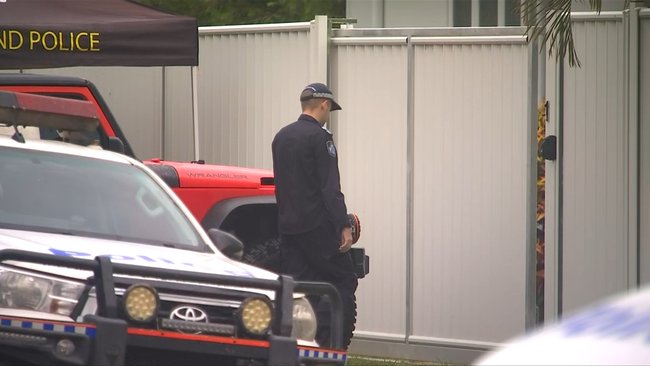 Officers establish a crime scene at the Mareeba home as investigations into the woman’s death get underway.