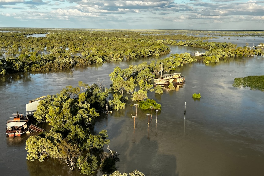 Thompson river flooding with boat being refloated.