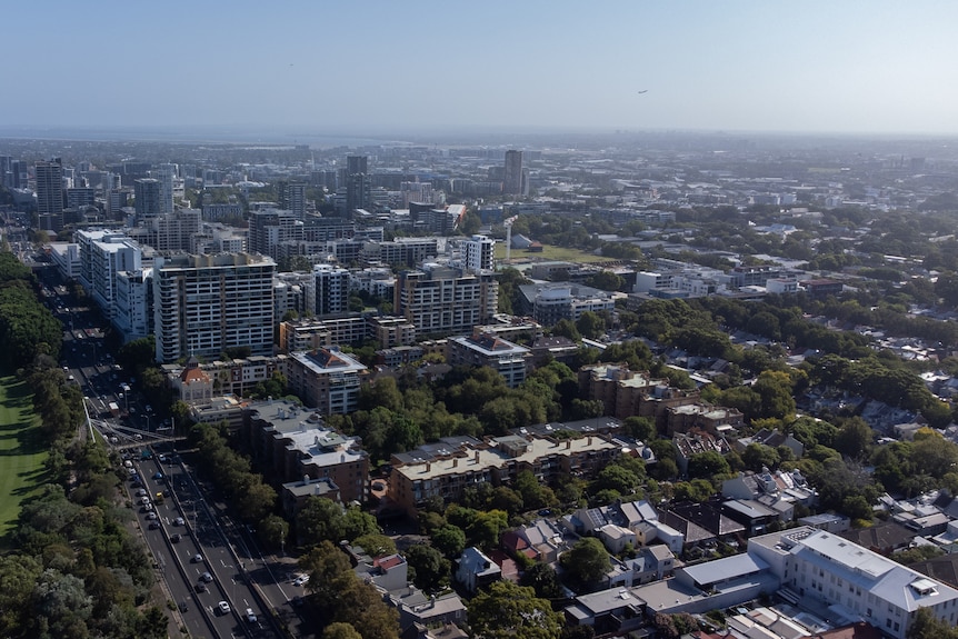 Aerial view of major roads and apartment blocks in the distance.