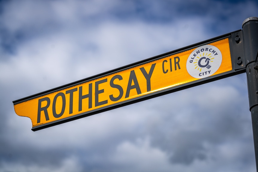 A yellow street sign