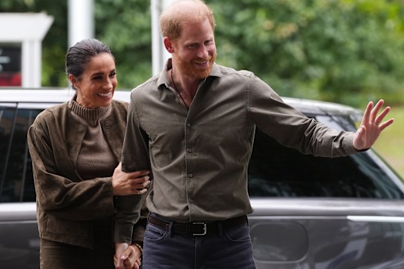 Meghan paired the jacket with a chunky knit and $889 suede skirt.