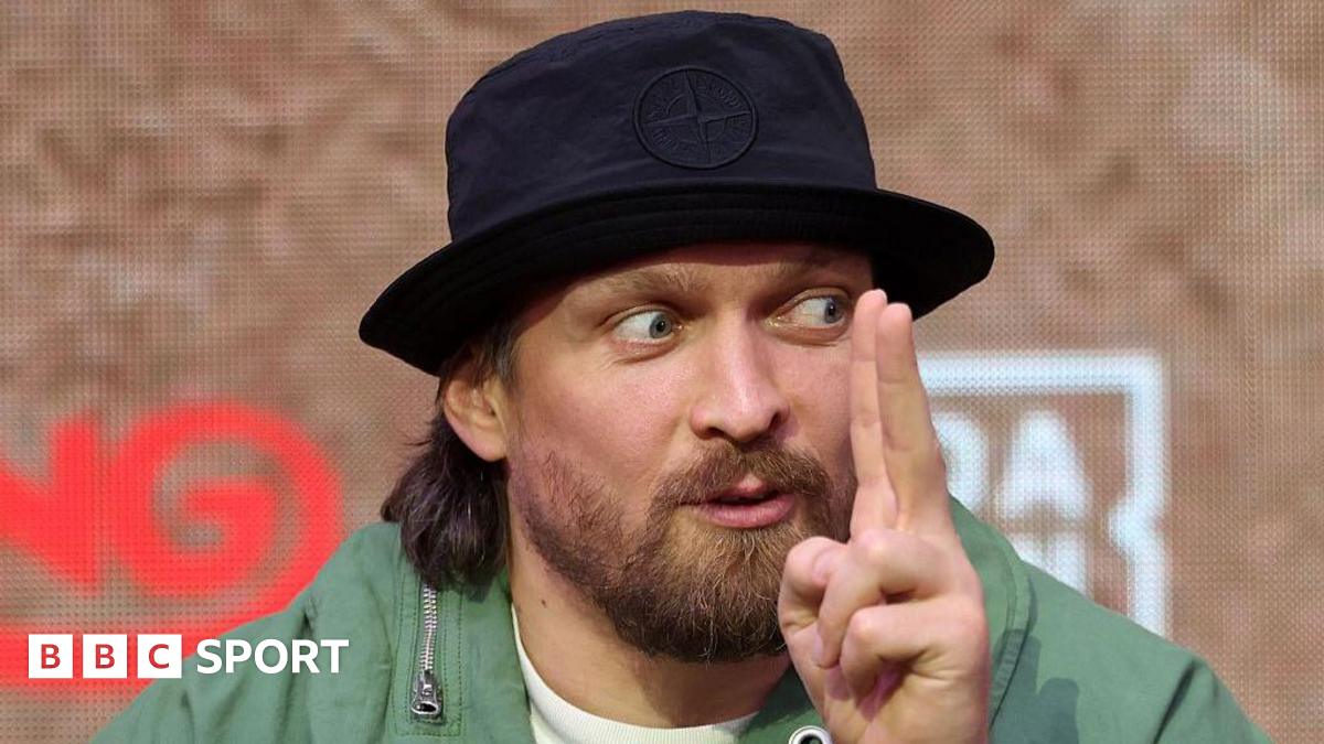 Oleksandr Usyk holds up his finger while speaking