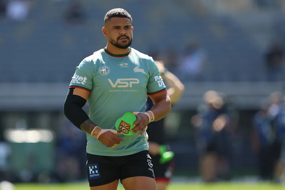 Latrell Mitchell warms up before a game.