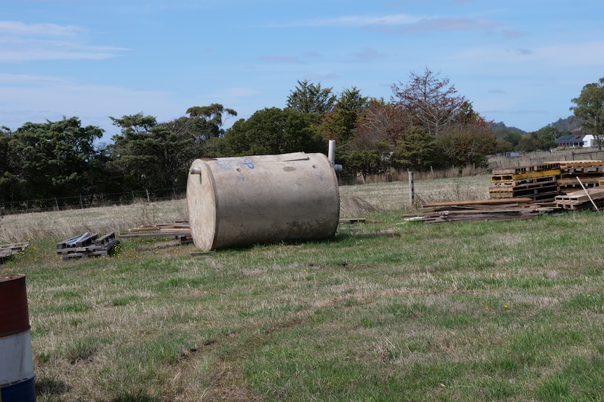 a septic tank lays in a field
