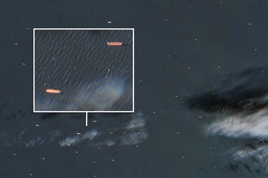 A satellite image of hundreds of ships floating in the ocean.