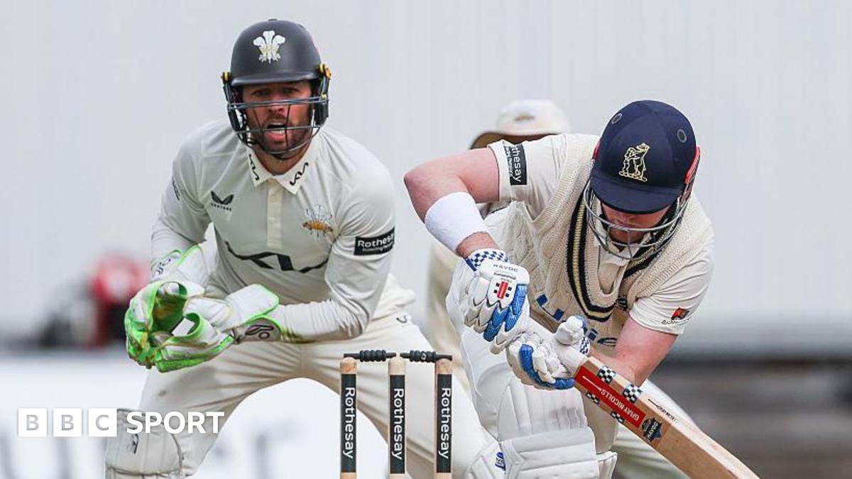 Left-handed Dan Mousley watchfully turns a ball to the legside as Surrey wicketkeeper Ben Foakes watches behind the stumps