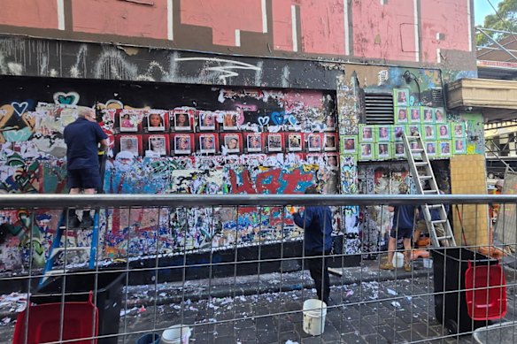 Workers remove the She Matters mural in Hosier Lane, Melbourne.