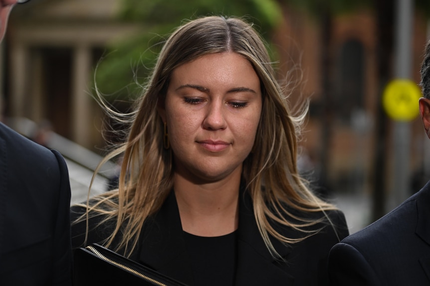 Close up of Brittany Higgins with her head down.