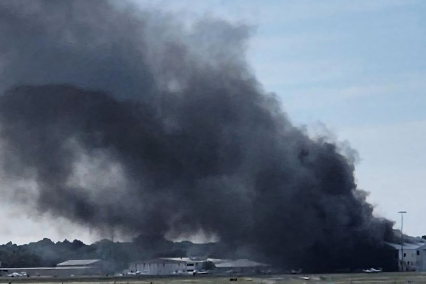 Black smoke coming from sheds on the ground