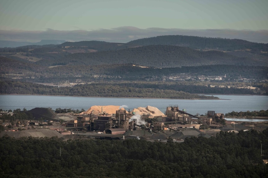 Aerial view of a smelter facility near a waterway.