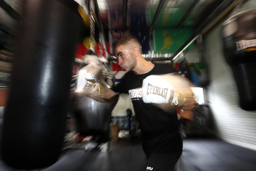 Boxer punching the heavy bag in a gym during a training session