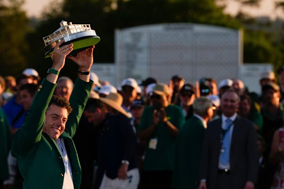 McIlroy raises the trophy aloft.