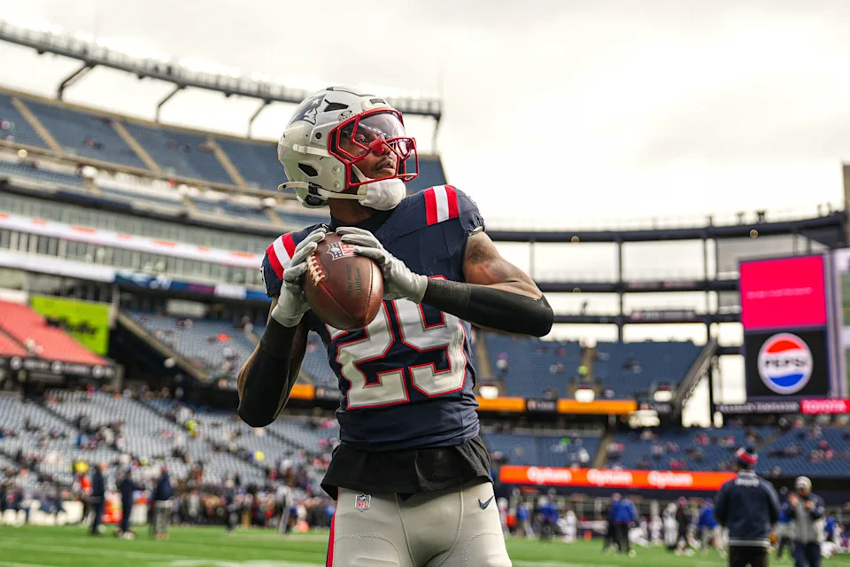 Jan 5, 2025; Foxborough, Massachusetts, USA; New England Patriots cornerback Isaiah Bolden (29) throws the ball to a fan during warm up before the start of the game against the Buffalo Bills at Gillette Stadium. Mandatory Credit: David Butler II-Imagn Images