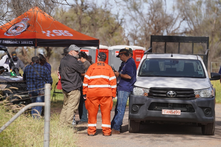 Volunteers gather near an SES tent
