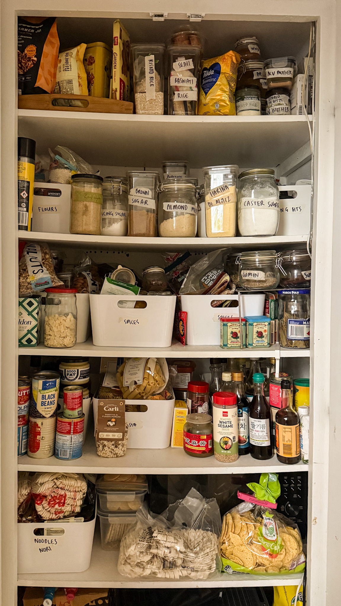 An organised — but very full — pantry that was previously a linen cupboard.