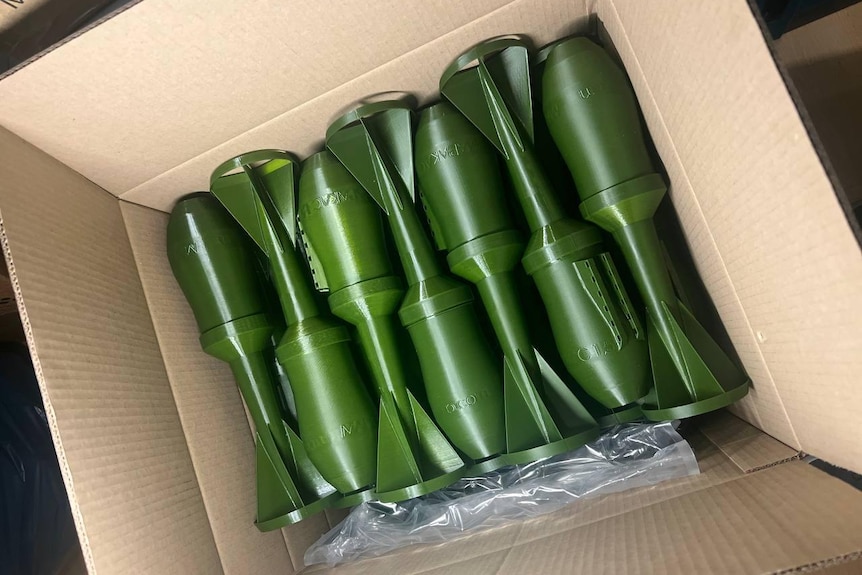 A box filled with 3D printed military equipment