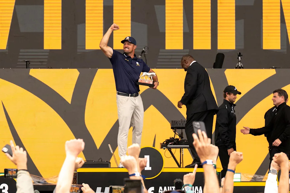 Bryson DeChambeau of Crushers GC holds the trophy next to South African President Cyril Ramaphosa during day four of LIV Golf South Africa at The Club at Steyn City on March 22, 2026 in Johannesburg.