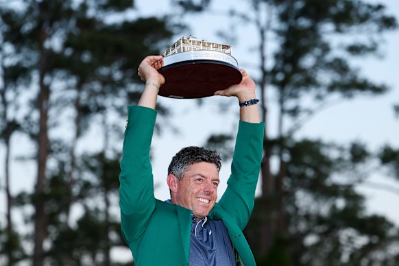 Rory McIlroy poses with the Masters trophy after winning in 2025.