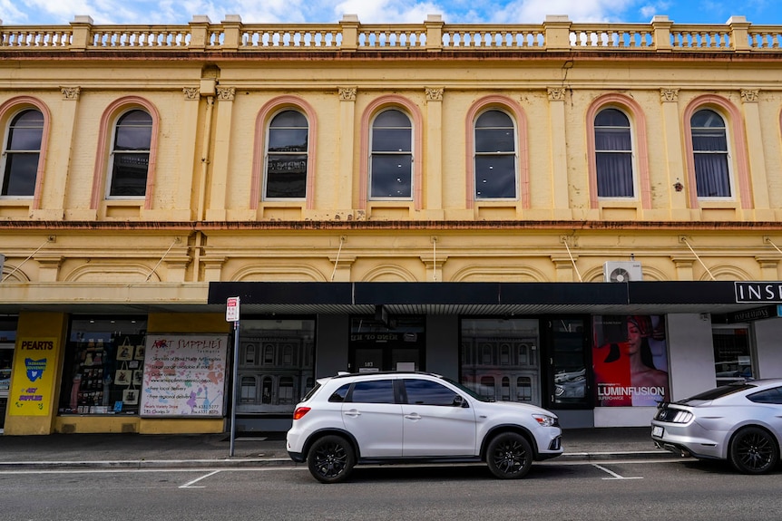 A two-storey shopfront and old street facade.
