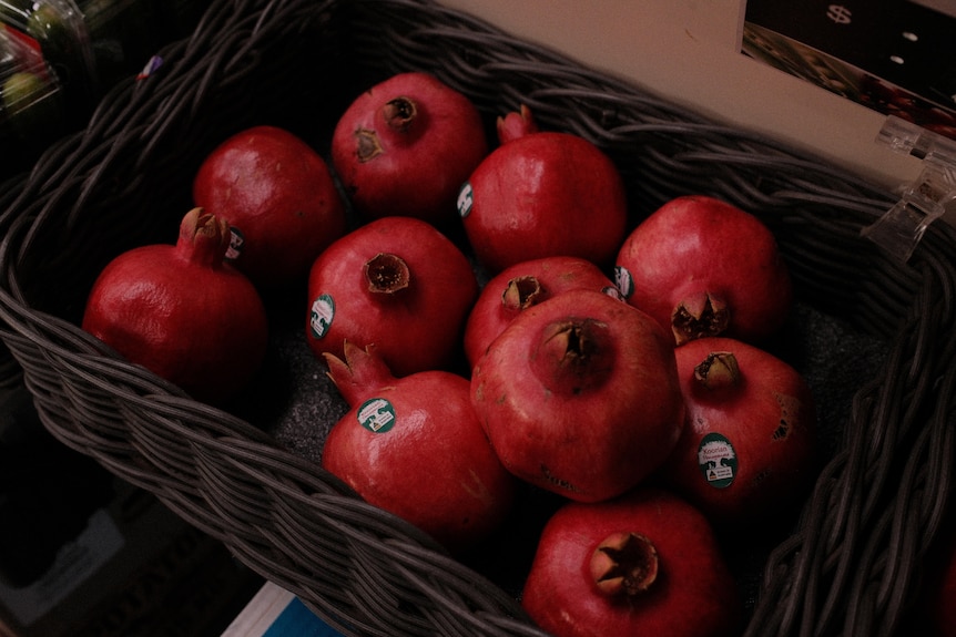 A basket of red pomegranates.