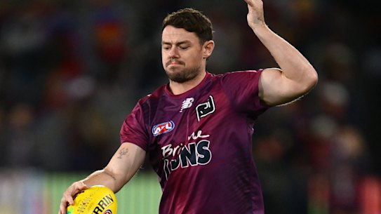 Lachie Neale of the Lions warms up.