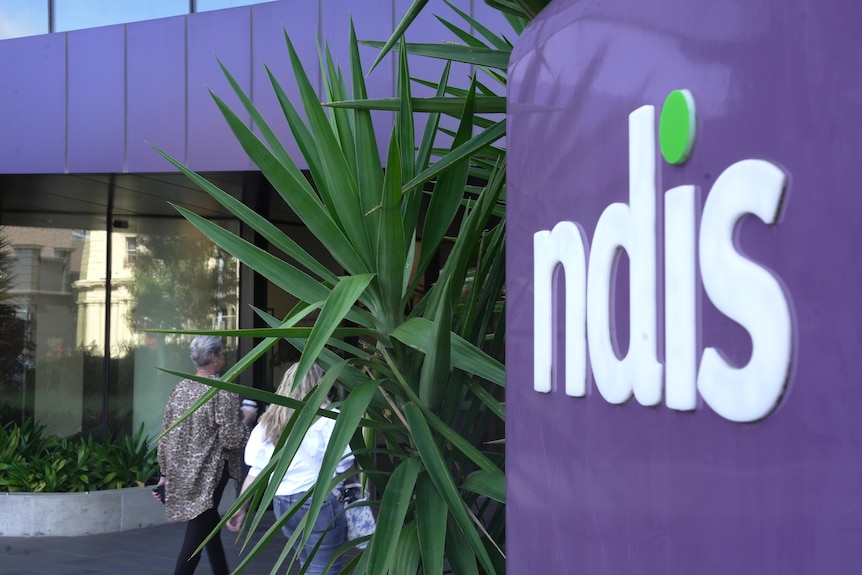 A close up of an NDIS sign next to a building