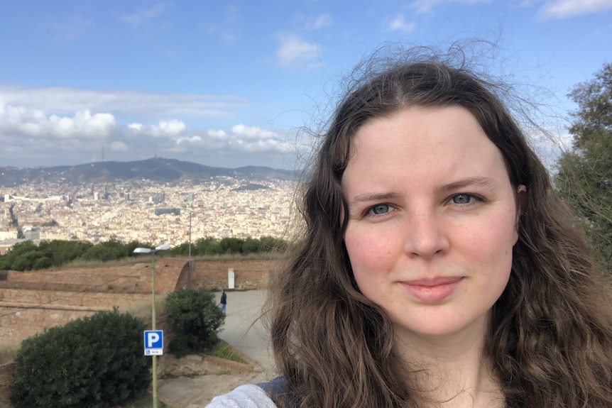 Woman with historic city in the background.