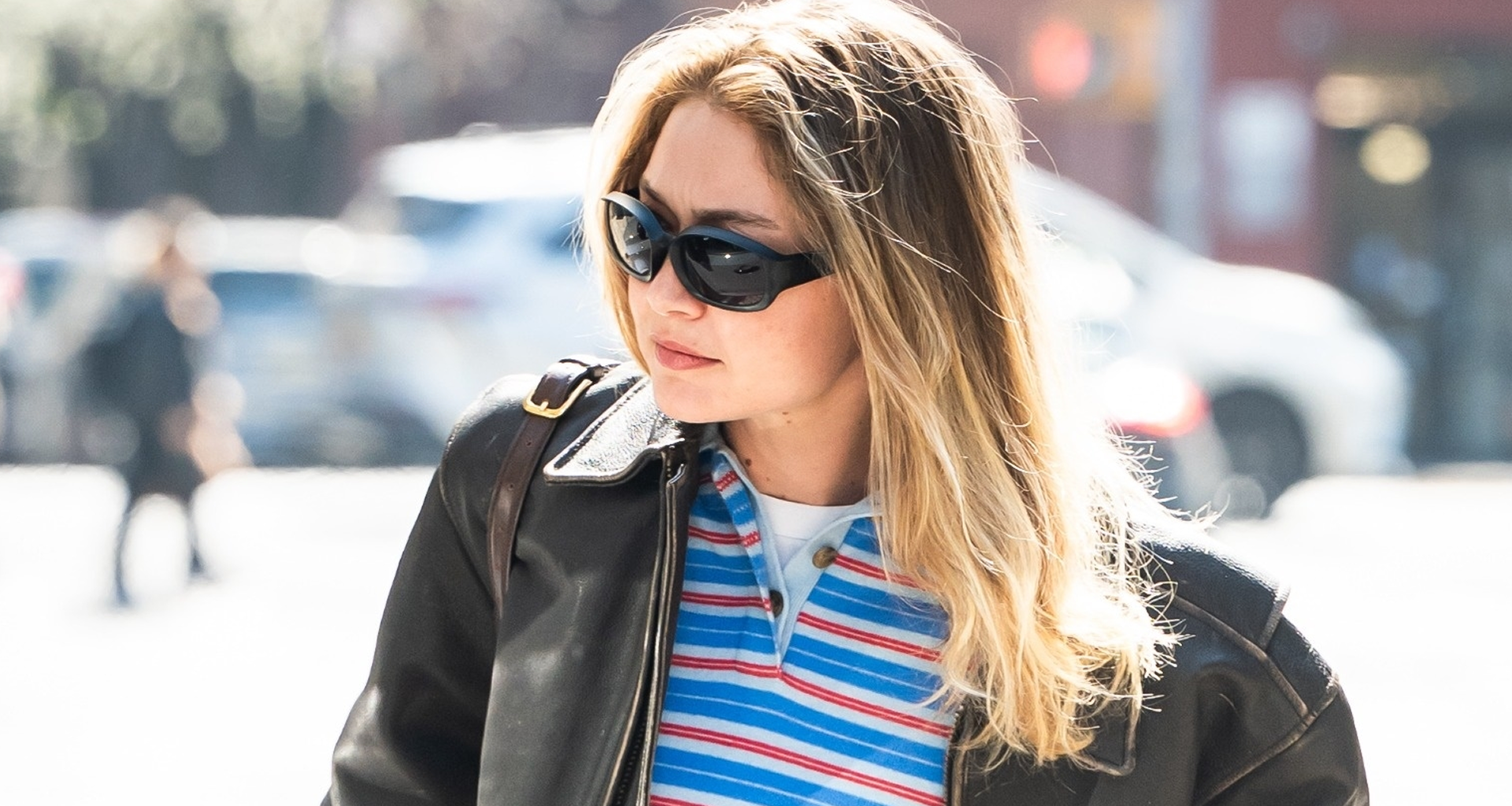Gigi Hadid wore the rugby shirt trend with a leather bomber jacket and straight-leg jeans