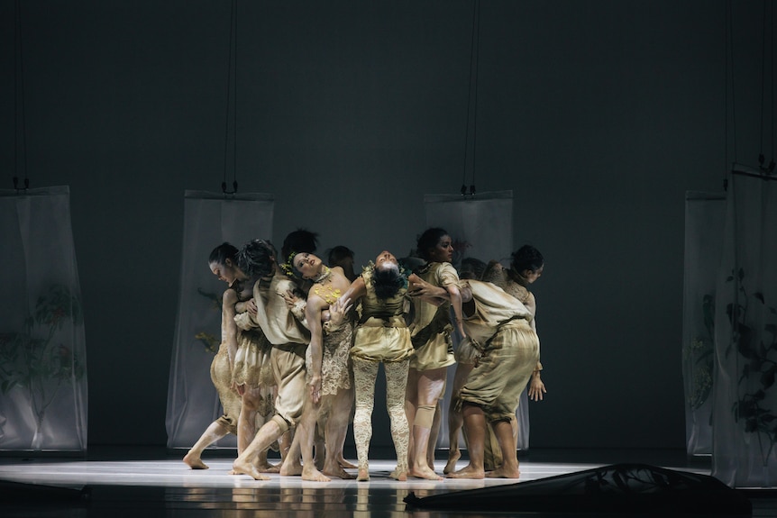 group of dancers doing suspended on stage in Bangarra Dance Theatre's work Flora