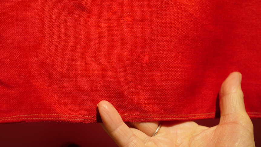 The prepared backing sheet on the restored ensign camouflages the flag's flaws.